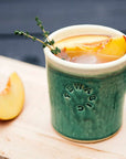 These Rocks cups feature the matte green Pewabic Green glaze. The inner lining and lip of the cup have a creamy white color.