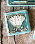 The background of Style B is the crystalline, shimmering deep green Viridian glaze with a pale blue border.