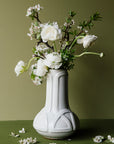 The Celtic Vase's base starts out wide and round at the bottom then becomes a straight pillar as it continues upward with a winding line design that has no beginning or end.