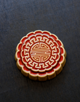 A Mooncake Paperweight in two-tone Scarlet/Honey.
