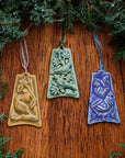 Three ornaments are against a white background. One has an image of a partridge sitting on a branch with a pear in the background, one shows two turtle doves resting on a tree branch and the last has three chickens in a row, each getting smaller as they are further from the viewer.