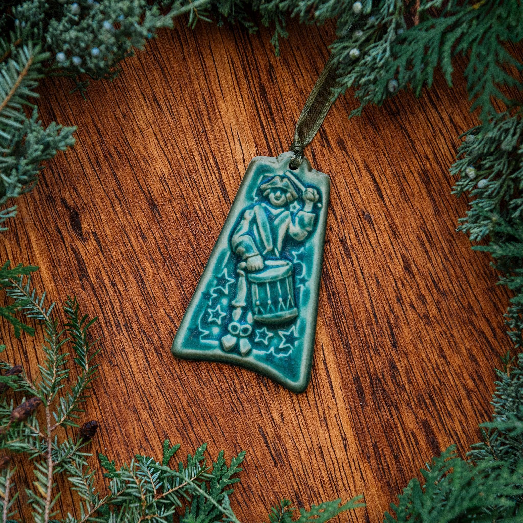 This ornament comes in a matte turquoise green glaze with a pale green ribbon.