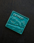  This Detroit Skyline Tile features the matte turquoise Pewabic Blue glaze.