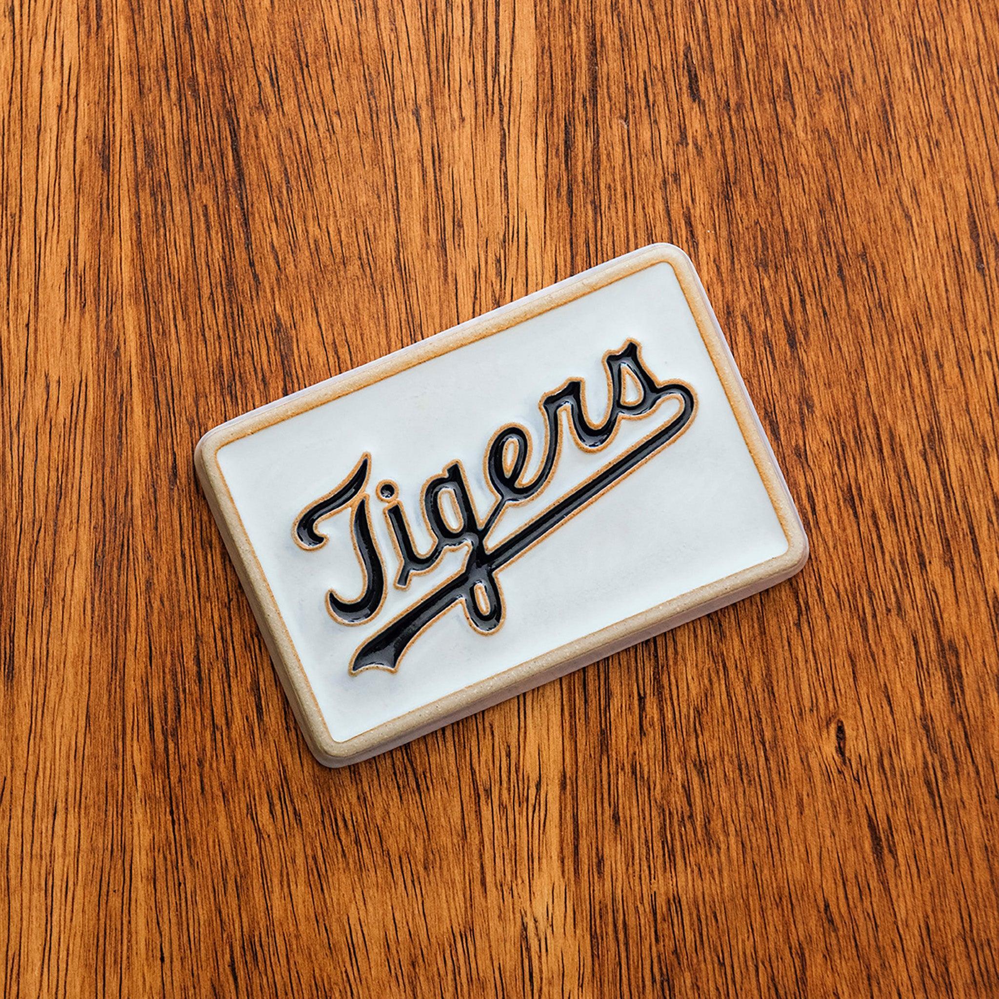 Rectangular 4x6 tile with 'Tigers' branding on a wooden surface.