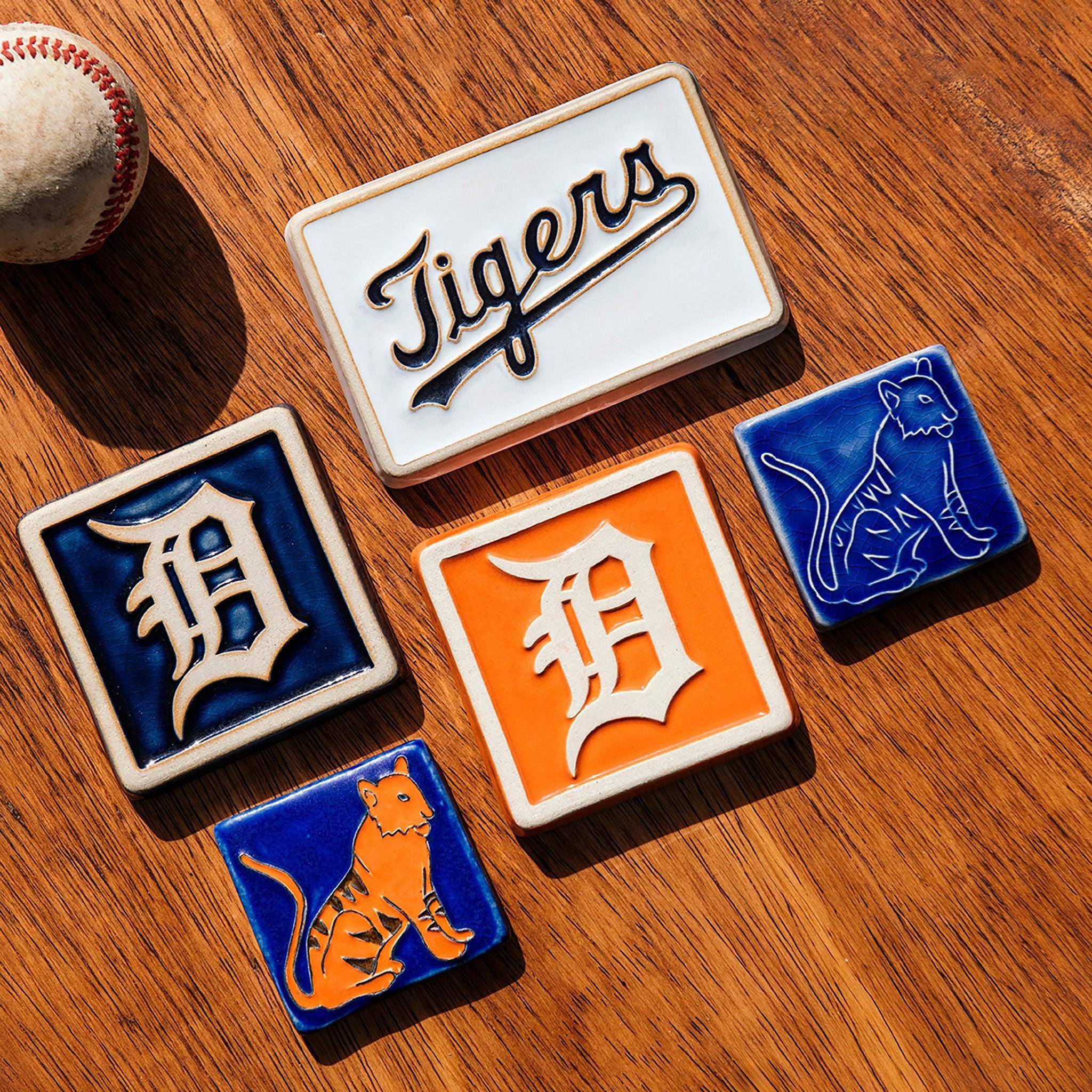 Collection of Detroit Tigers-themed tiles on a wooden surface.
