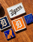 Collection of Detroit Tigers-themed tiles on a wooden surface.
