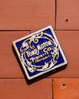 Ford Motor Co. Piquette logo tile on a terra cotta roof tile background.