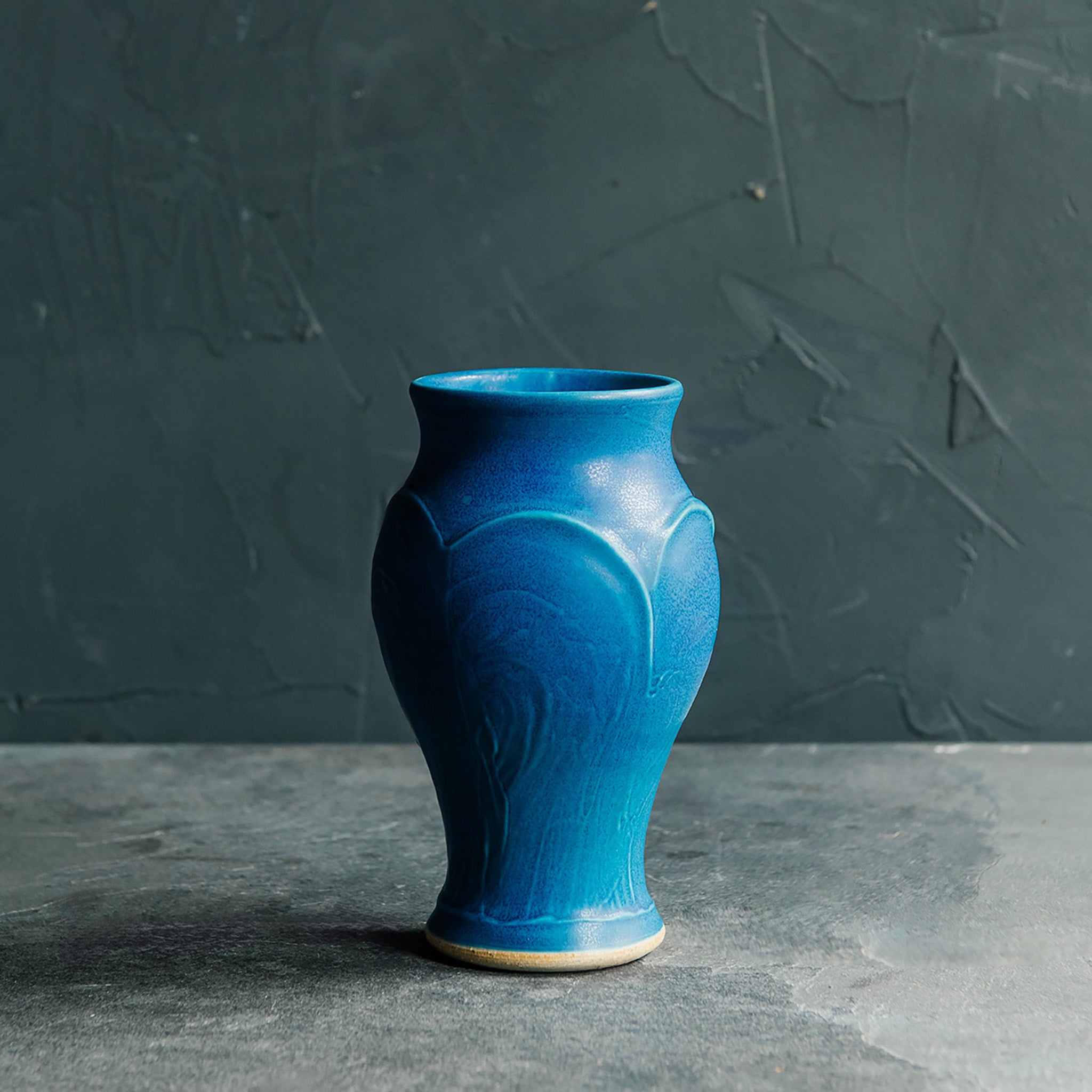 The Peacock glaze is a matte french blue color.