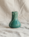 Elm-glaze Snowdrop vase on a natural canvas material in off-white.