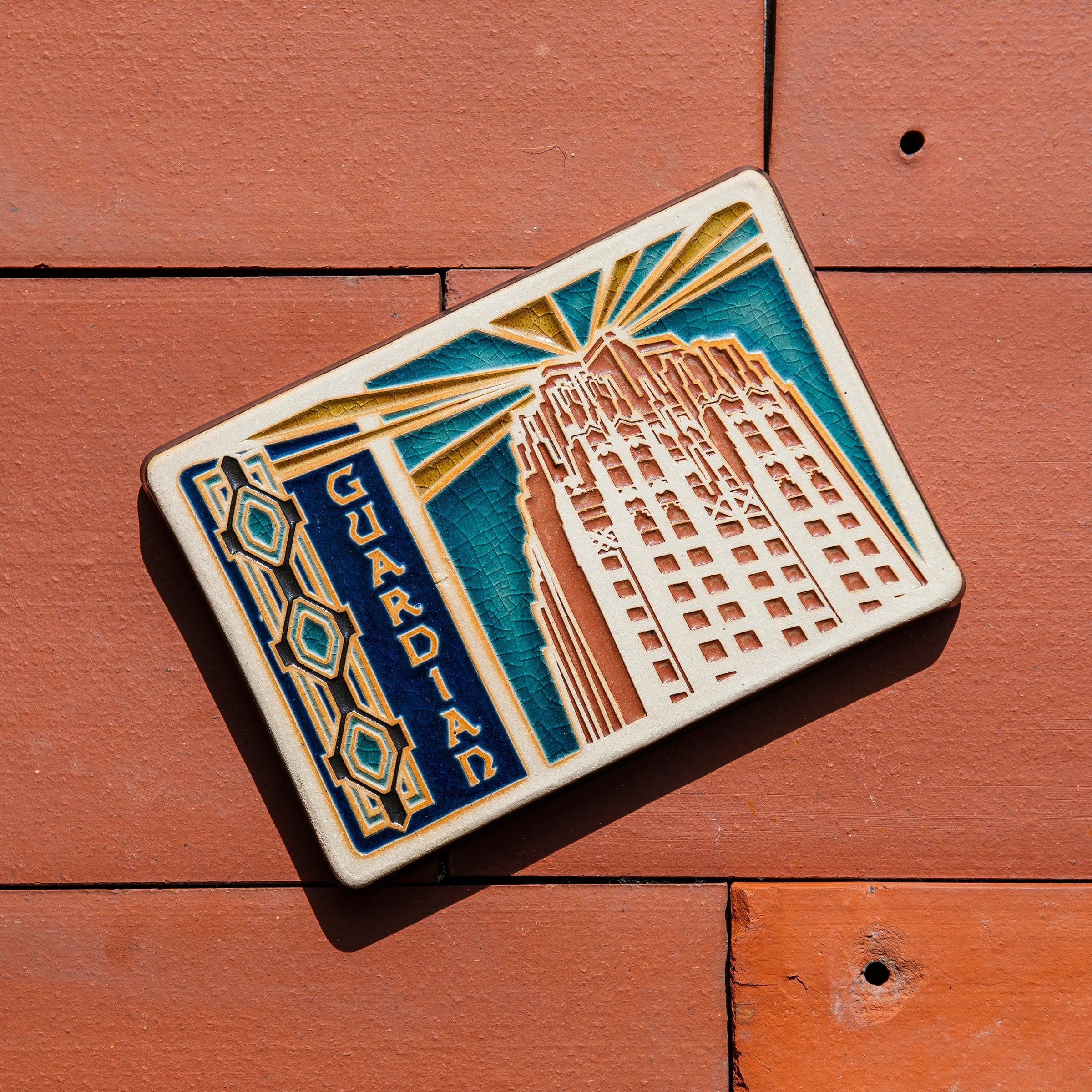 The Guardian Building Postcard tile depicts the building's iconic facade and
'Guardian' text on the terracotta roof tiles. 