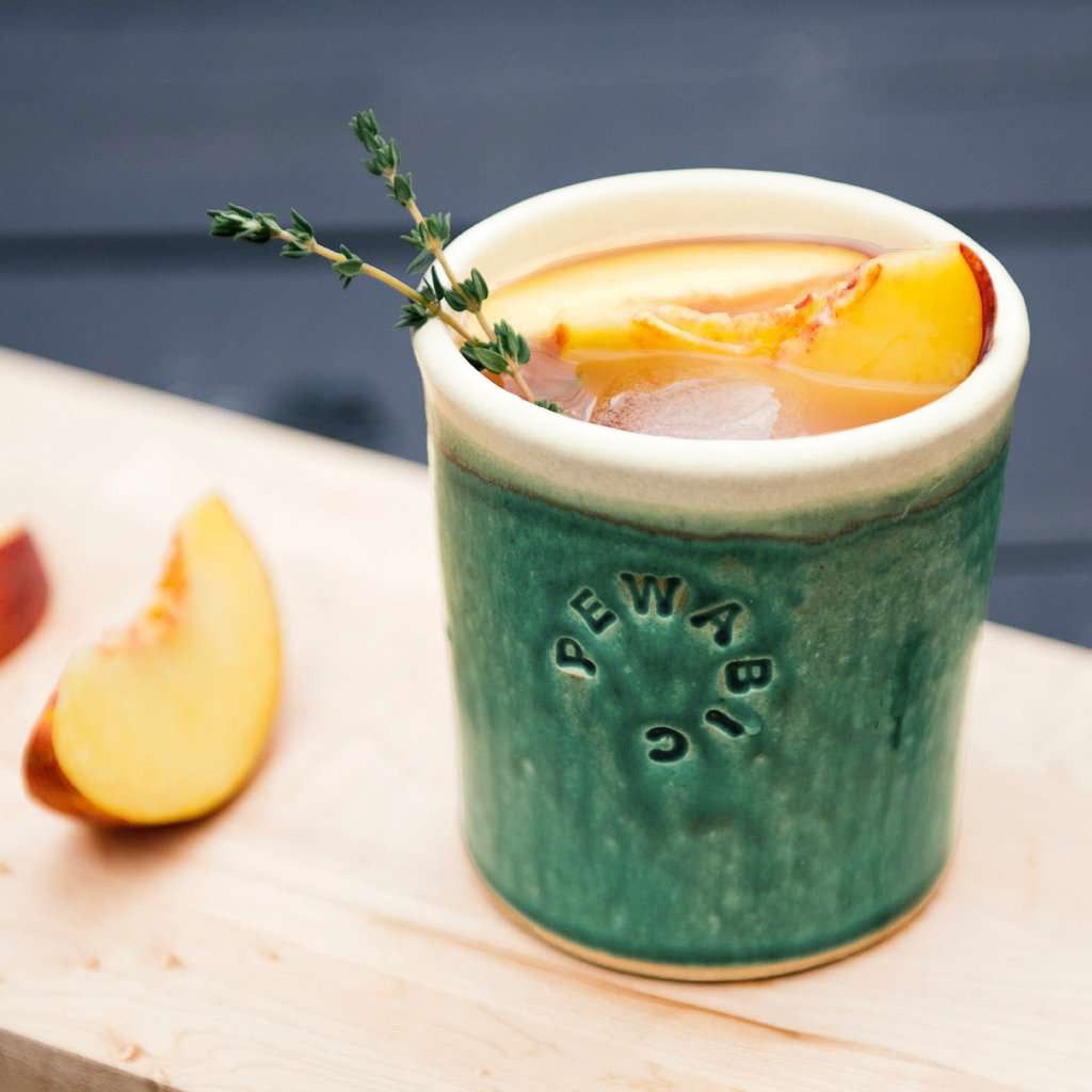 These Rocks cups feature the matte green Pewabic Green glaze. The inner lining and lip of the cup have a creamy white color.