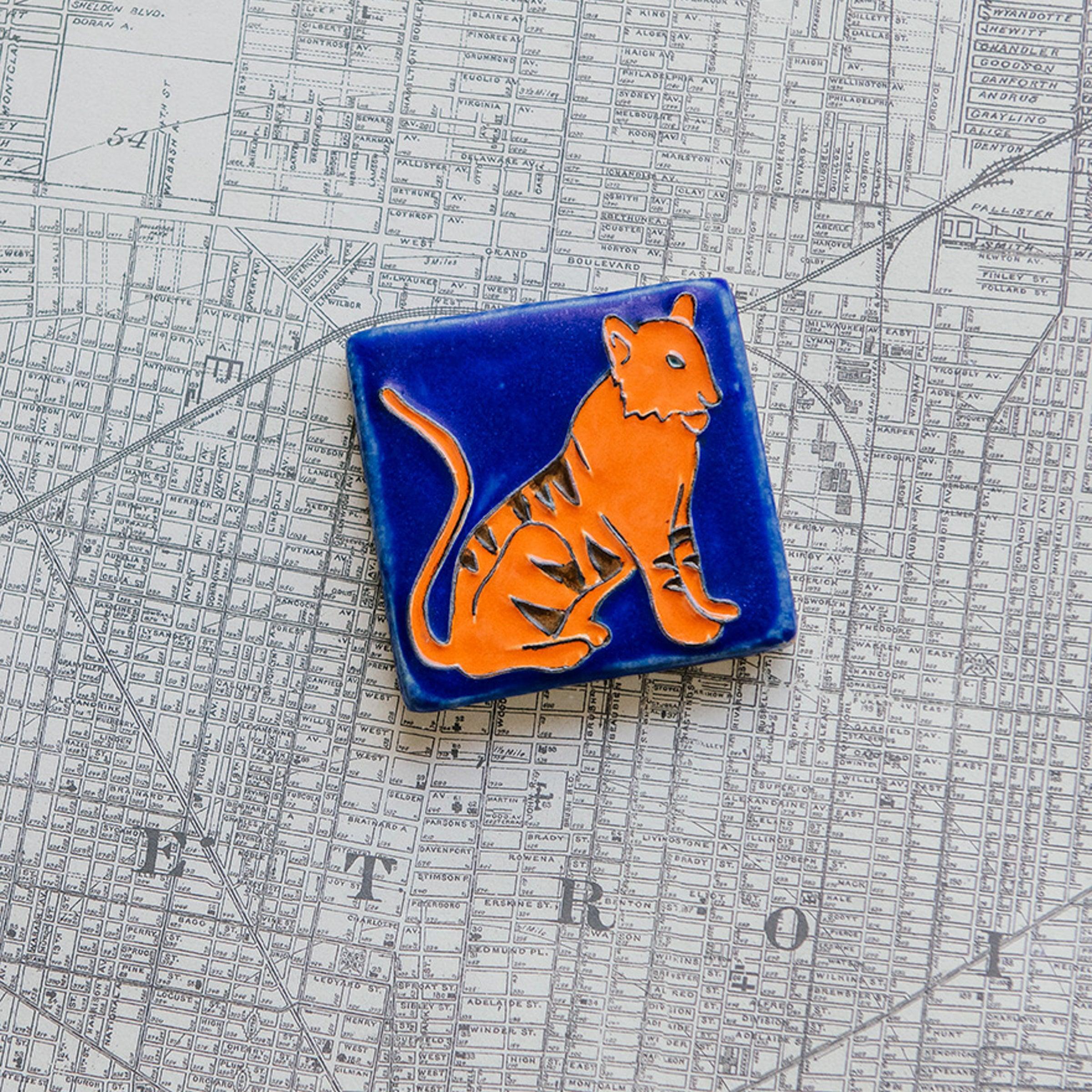 Hand-painted 3x3 Tigers tile on a Detroit map background.