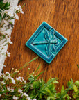 This Dragonfly Tile features the matte bluish-green Pewabic Blue glaze. 