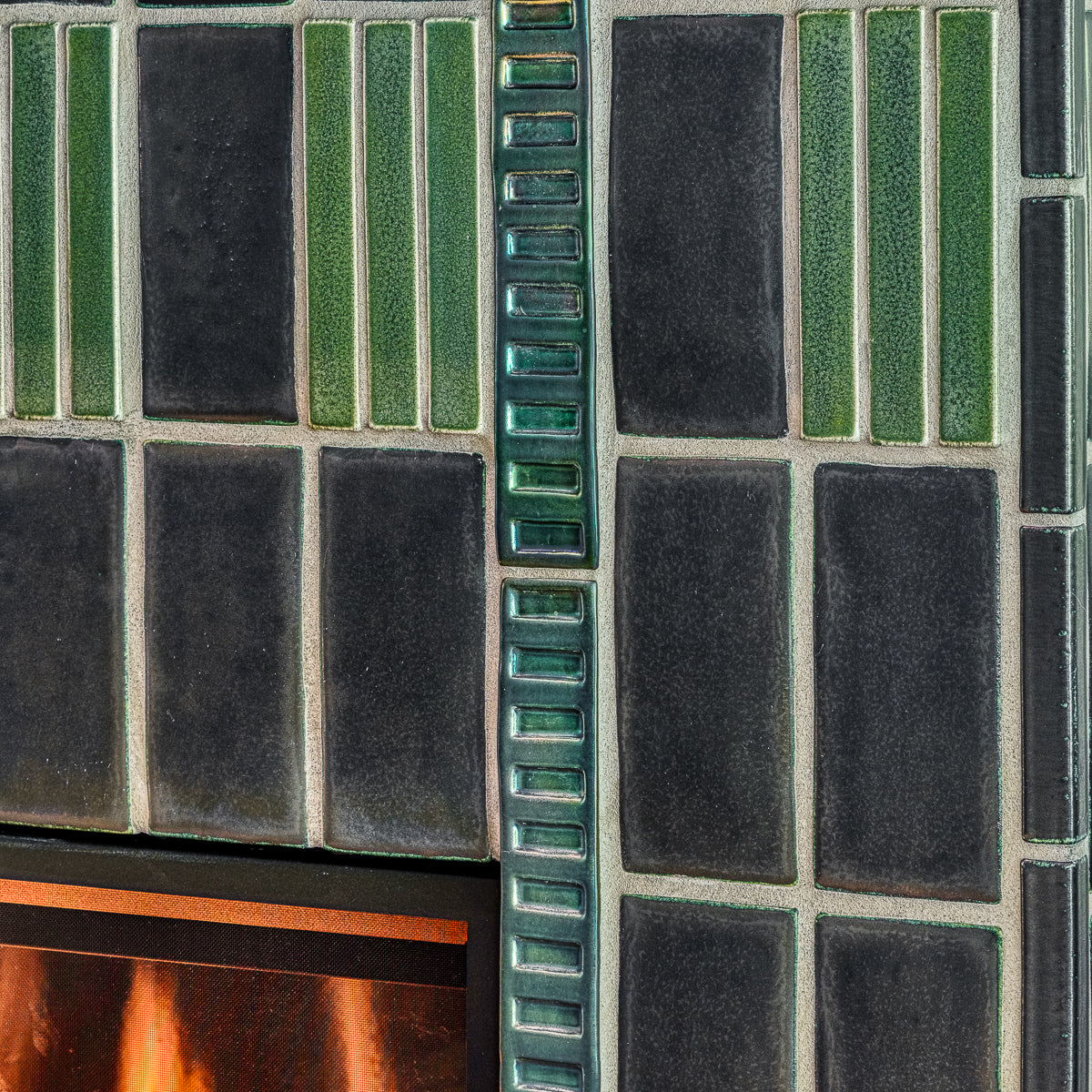 Detail photo of the tile texture. You can see the light reflecting off of the Gunmetal, Rain, and Aurora Iridescent glazed tiles.